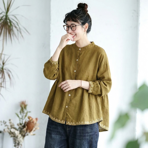イエローの前ボタン長袖シャツの袖口と裾の刺繍が見える着用イメージ